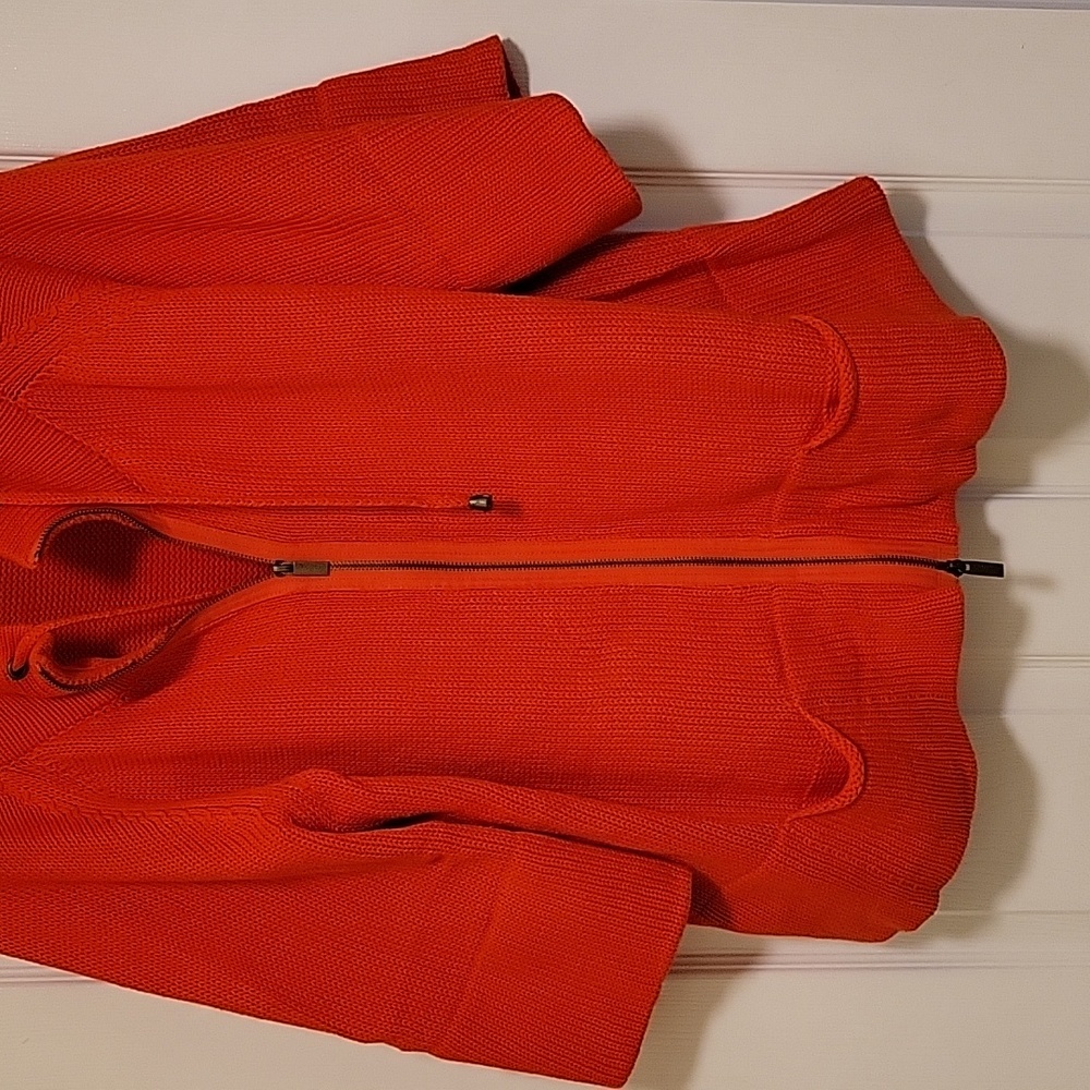 Orange zip front sweater.